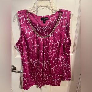 Pink and white sleeveless blouse with gold neck trim.